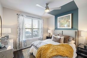 Mckinney apartment for rent - a bedroom with a large bed and a ceiling fan