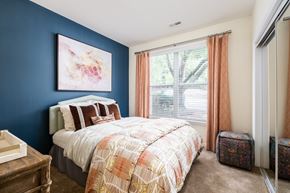 Cornelius apartment for rent - A bedroom with a bed, nightstand, and a painting on the wall.