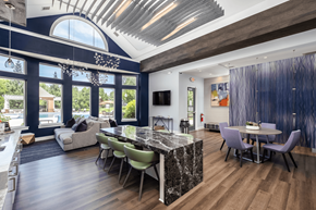 Concord apartment for rent - A modern kitchen with a marble island and a dining table set for four.