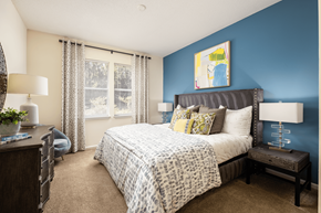 Concord apartment for rent - A bedroom with a large bed and a blue wall.