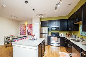 Concord apartment for rent - A kitchen with black cabinets and a white island.
