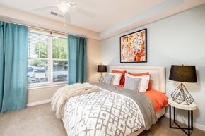 Concord apartment for rent - A bedroom with a large bed and a ceiling fan.