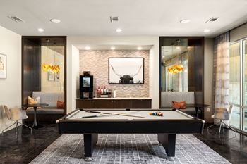 Resident game lounge with billiards, shuffleboard, and arcade games