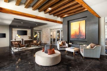 Georgetown apartment for rent - A modern living room with a wooden ceiling and a large painting on the wall.