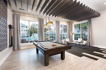 Cary apartment for rent - a pool table in a living room with windows