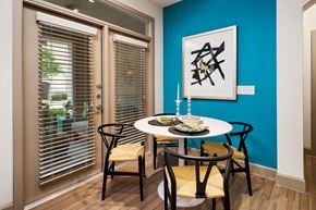 Flower Mound apartment for rent - a dining room with a table and chairs and a blue wall