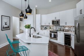 Nashville apartment for rent - a large kitchen with white cabinets and a sink