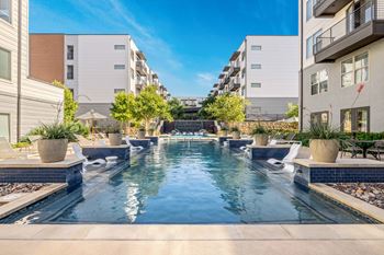 Resort-style swimming pool with fountains