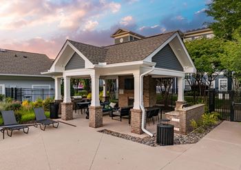 Poolside summerhouse with fireplace, dining areas, and tvs