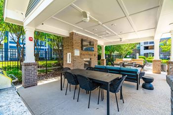 Poolside summerhouse with fireplace, dining areas, and tvs