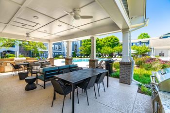 Poolside summerhouse with fireplace, dining areas, and tvs