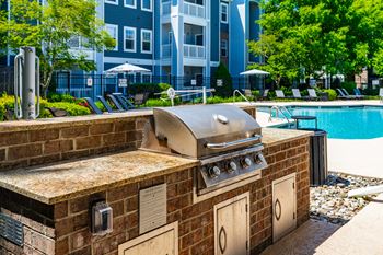 Poolside summerhouse with fireplace, dining areas, and tvs