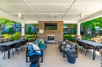 Poolside summerhouse with fireplace, dining areas, and tvs
