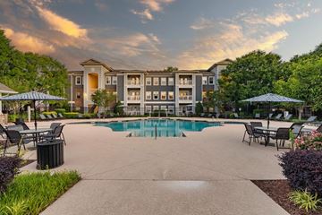 Cary apartment for rent - A large building with a pool in front of it.