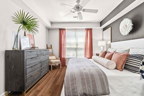 Raleigh apartment for rent - A bedroom with a large bed and a ceiling fan.