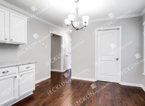 Henrico house for rent - A room with white cabinets and a chandelier.