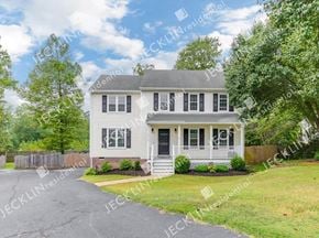 Henrico house for rent - A white house with a grey roof and a black door.