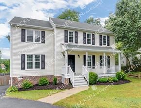 Henrico house for rent - A two-story house with a front porch and a small front yard.