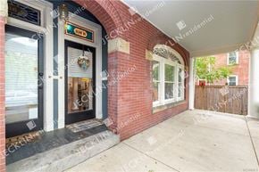 Richmond house for rent - A red brick house with a black door and a window with white frame.