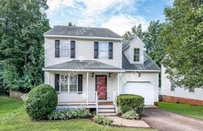 Henrico house for rent - A two-story house with a red door and a white garage.