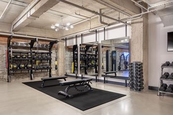 Crossfit-style gym with punch/speed bags and pelotons