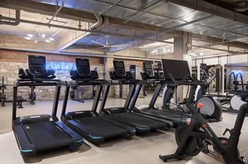 Crossfit-style gym with punch/speed bags and pelotons