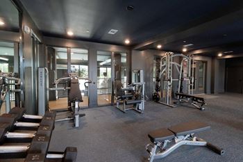 Cardio and strength training fitness center with eschelon and peloton bikes and fitness mirrors