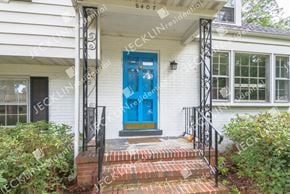 Henrico house for rent - A white house with a blue door and a black gate.