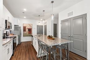 Duluth apartment for rent - A kitchen with a table and chairs in the middle of the room.