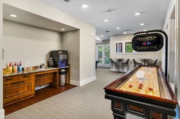 Game room with shuffleboard and coffee bar