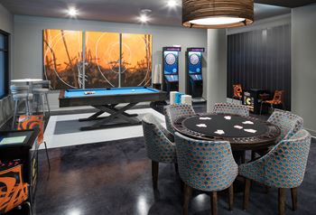 Game room with billiards, foosball, shuffleboard, darts, vintage arcade gaming system, poker and tvs