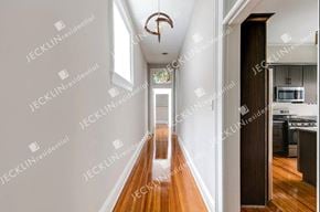 Richmond house for rent - a long hallway with white walls and hardwood floors