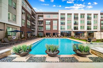 Resort-style pool with tanning ledge and private cabanas