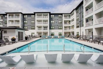 Resort-style pool with tanning ledge and sundeck