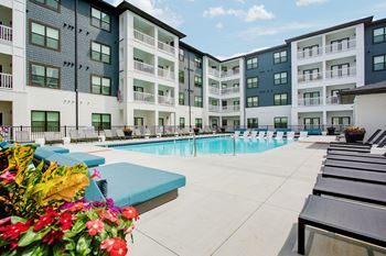 Resort-style pool with tanning ledge and sundeck