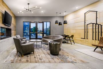 Nashville apartment for rent - a living room with couches and chairs and a television