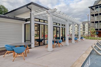 Resort-style swimming pool with tanning ledge, cabanas and sundeck