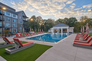 Resort-style swimming pool with tanning ledge, cabanas and sundeck