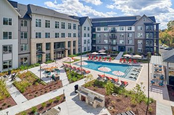 Resort-style swimming pool with tanning ledge, cabanas and sundeck