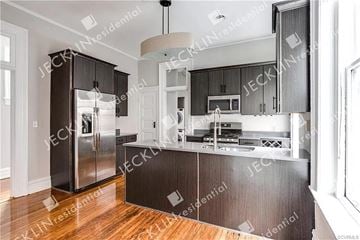 Richmond house for rent - A modern kitchen with dark wood cabinets and stainless steel appliances.