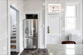 Richmond house for rent - A kitchen with a white fridge and a white door.