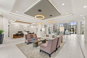 Buford apartment for rent - A spacious lobby with a reception desk and seating area.