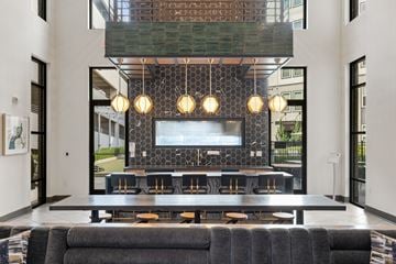 Atlanta apartment for rent - A modern living room with a black couch and a television.