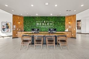Atlanta apartment for rent - A conference room with a green plant wall and a long table with chairs.