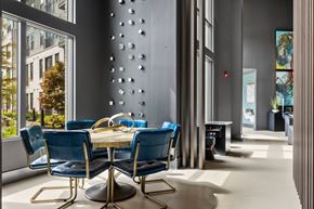 Duluth apartment for rent - A dining room with a table surrounded by blue chairs.