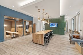 Chamblee apartment for rent - A modern dining room with a long wooden table and chairs.