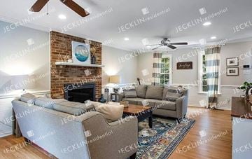 Henrico house for rent - A living room with a grey sofa set and a fireplace.