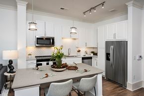 Buford apartment for rent - a kitchen with white cabinets and stainless steel appliances