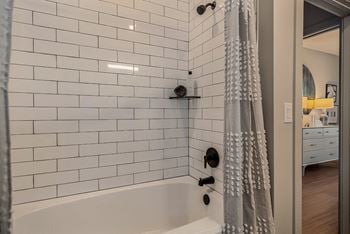 Tiled shower surrounds to the ceiling
