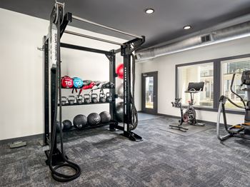 24-Hour cardio and strength training fitness center featuring peloton bike, hub training system, water rower, free weights and more!